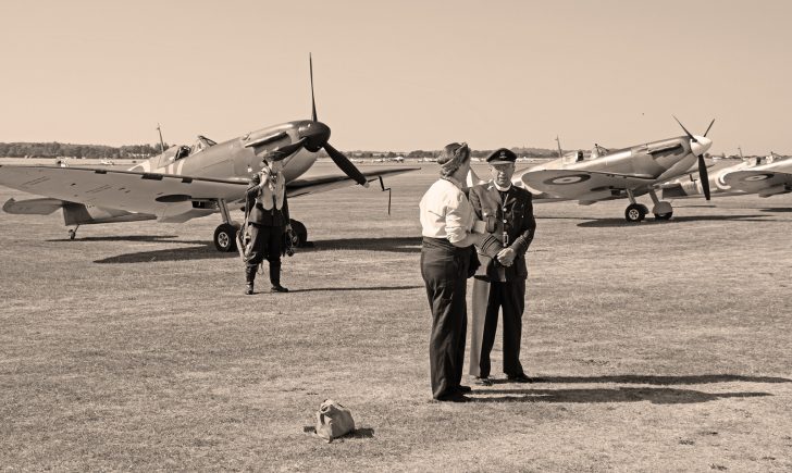 RAF pilot, chaplain and woman in front of Supermarine Spitfires, Flying Legends Duxford