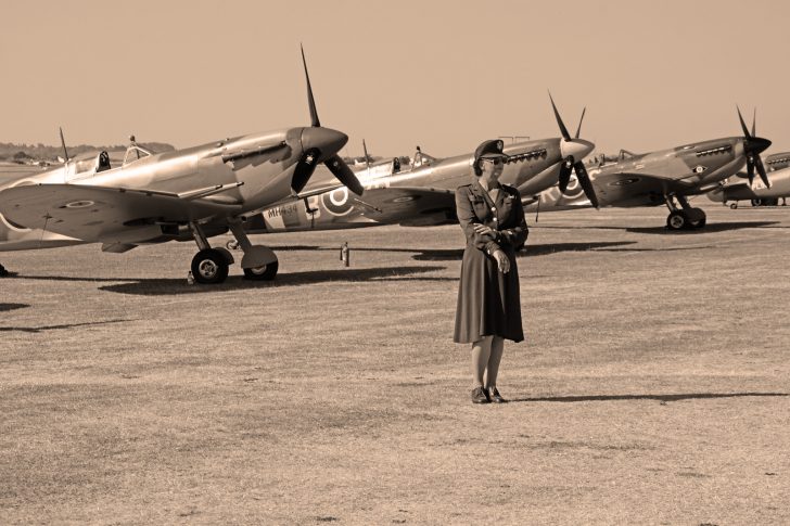 member of the Women's Royal Air Force in front of Spitfires, Flying Legends Duxford