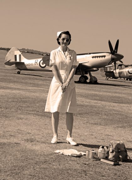 Nurse in front of Spitfire FR Mk.XVIIIe SM845/R (G-BUOS) 28 Sq RAF, Flying Legends Duxford