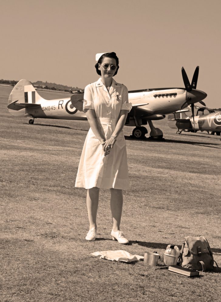 Nurse in front of Spitfire FR Mk.XVIIIe SM845/R (G-BUOS) 28 Sq RAF, Flying Legends Duxford