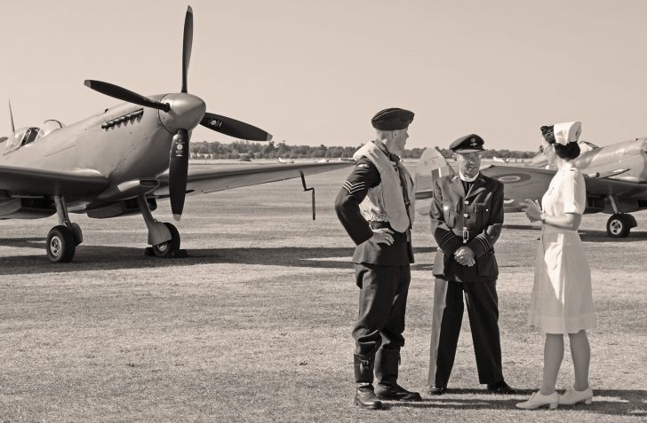 RAF pilot, chaplain and nurse in front of Spitfires, Flying Legends Duxford